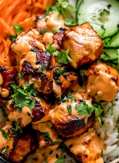 Delicious Bang Bang Salmon Bowl topped with fresh ingredients and spicy sauce.
