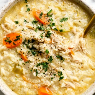 Bowl of homemade Chicken Rice Soup with carrots and herbs