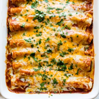 Delicious plate of easy chicken enchiladas topped with cheese and cilantro