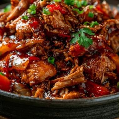 Slow Cooker Sweet Chili Chicken in a bowl garnished with green onions