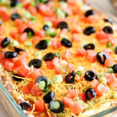 Delicious ultimate seven layer bean dip served in a colorful dish