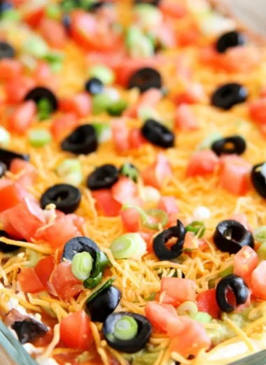 Delicious ultimate seven layer bean dip served in a colorful dish