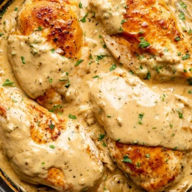 Creamy Boursin Chicken dish served on a plate with herbs and sides.