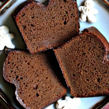 Moist Christmas gingerbread loaf cake with spices and festive decorations.