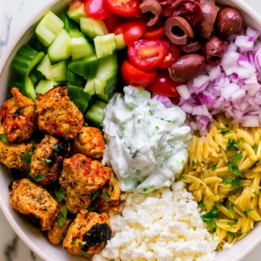 High-protein chicken gyro bowls with fresh vegetables and sauce served in a bowl