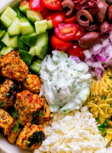 High-protein chicken gyro bowls with fresh vegetables and sauce served in a bowl