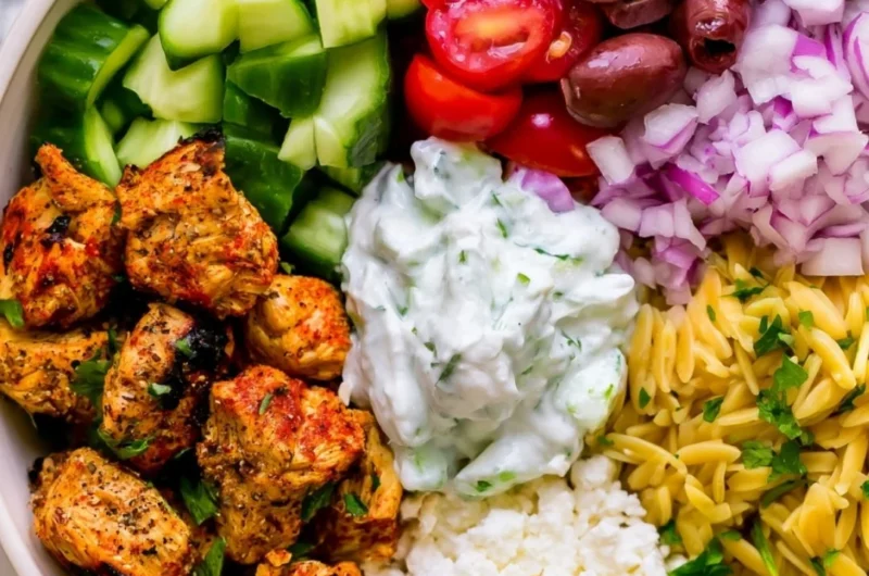 High-protein chicken gyro bowls with fresh vegetables and sauce served in a bowl
