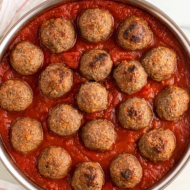 Quick and easy baked meatballs on a wooden cutting board.