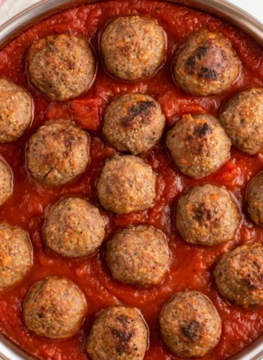 Quick and easy baked meatballs on a wooden cutting board.