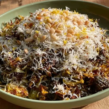 A plate of roasted shredded Brussels sprouts garnished with herbs.